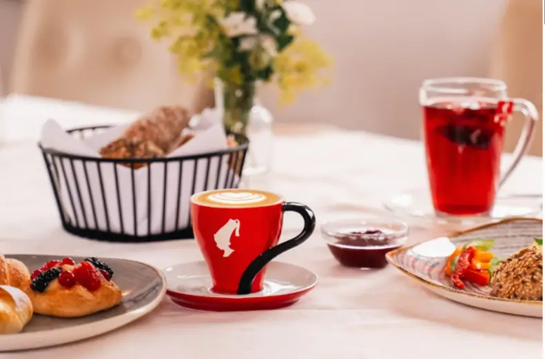 Breakfast on the table: coffee, tea, and pastries
